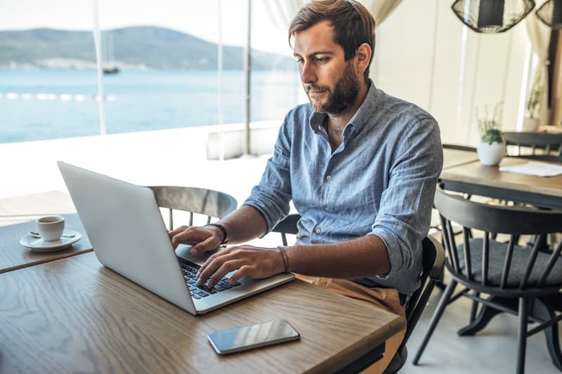 man writing on a laptop